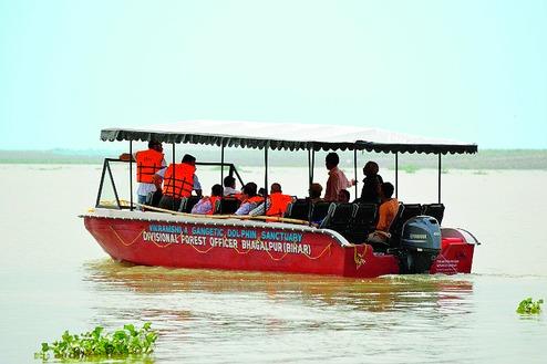 Visitors aboard a Forest Department river safari boat, VGDS